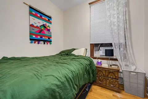 a bedroom with a bed and a bookshelf