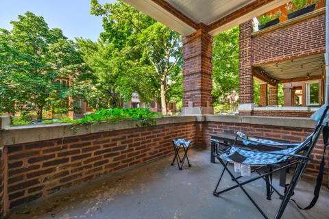 a wooden bench sitting in front of a building