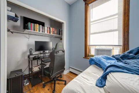 a view of a livingroom with workspace and a window