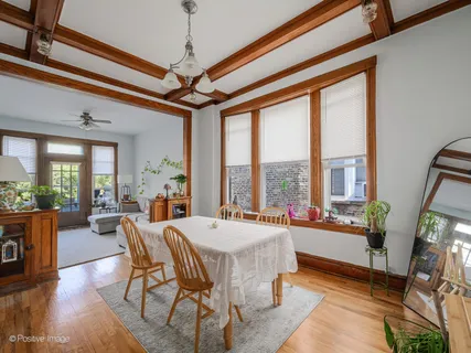 a view of a dining room with furniture large windows and wooden floor