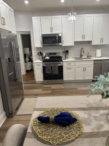 a kitchen with a sink a stove and refrigerator