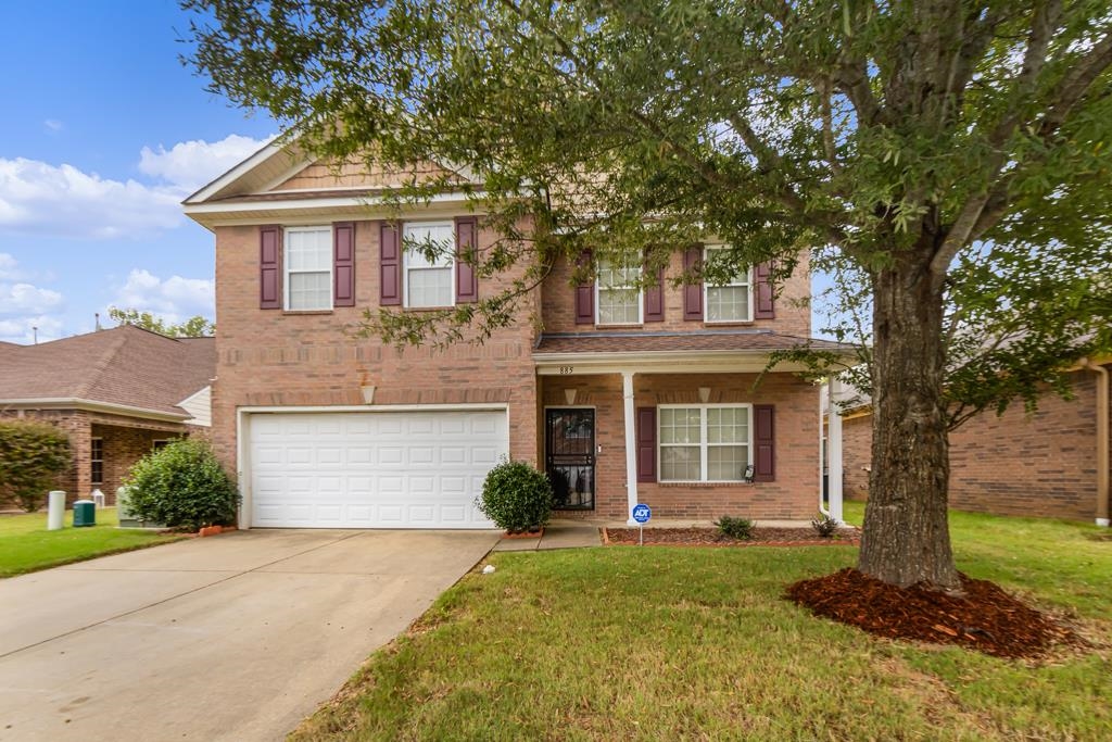 885 Ruby Creek Cove Memphis, TN 38109 - Photo 2 of 25 a front view of a house with a garden