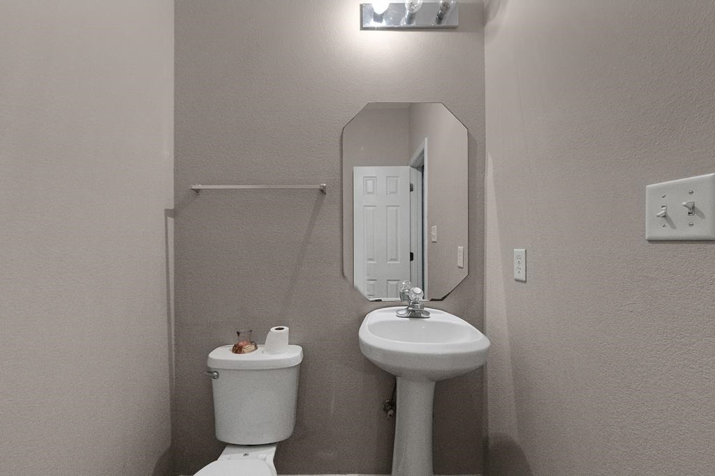 885 Ruby Creek Cove Memphis, TN 38109 - Photo 22 of 25 a bathroom with a sink and mirror with toilet