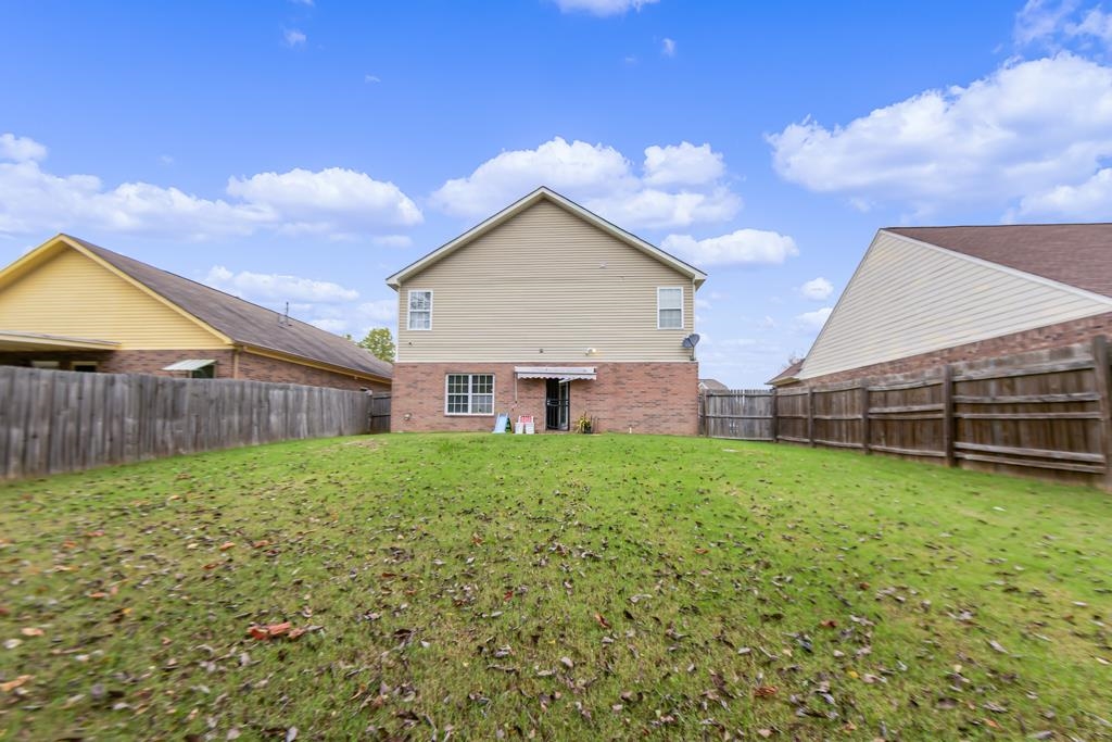 885 Ruby Creek Cove Memphis, TN 38109 - Photo 24 of 25 a view of a backyard with potted plants and wooden fence
