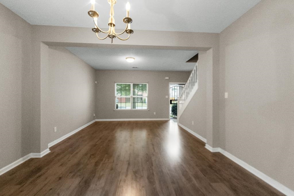885 Ruby Creek Cove Memphis, TN 38109 - Photo 5 of 25 wooden floor in an empty room with a window