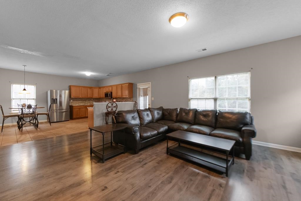885 Ruby Creek Cove Memphis, TN 38109 - Photo 9 of 25 a living room with furniture and a wooden floor