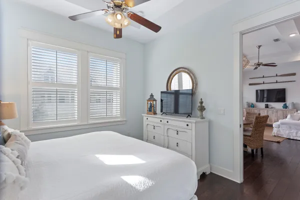 a bedroom with a bed and a chandelier