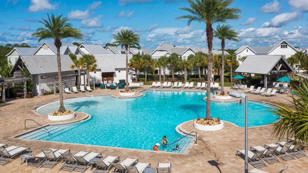 a swimming pool with outdoor seating and yard