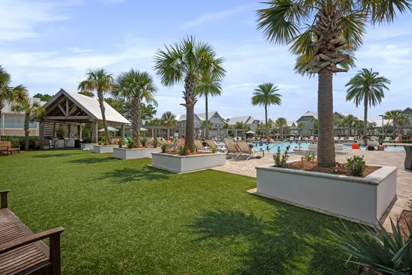 a view of a house with swimming pool and sitting area