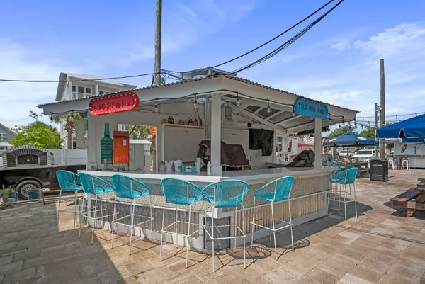 a view of a patio with a table and chairs and potted plants