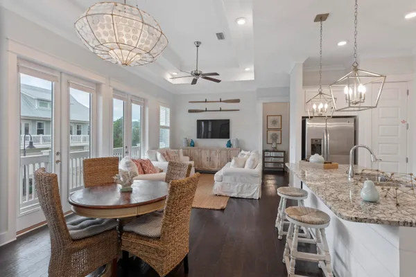 a view of a dining room with furniture a chandelier and wooden floor