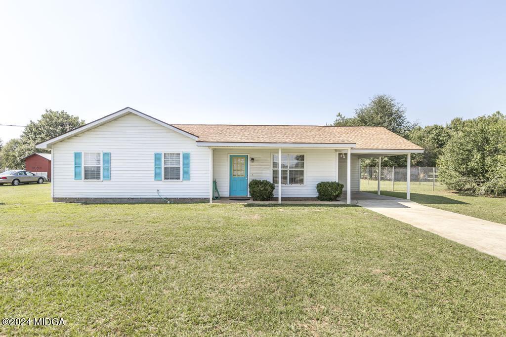 118 Toomer Road Perry, GA 31069 - Photo 1 of 30 a front view of a house with a garden