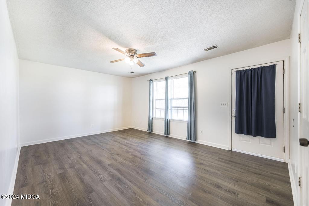 118 Toomer Road Perry, GA 31069 - Photo 11 of 30 wooden floor in an empty room with a window