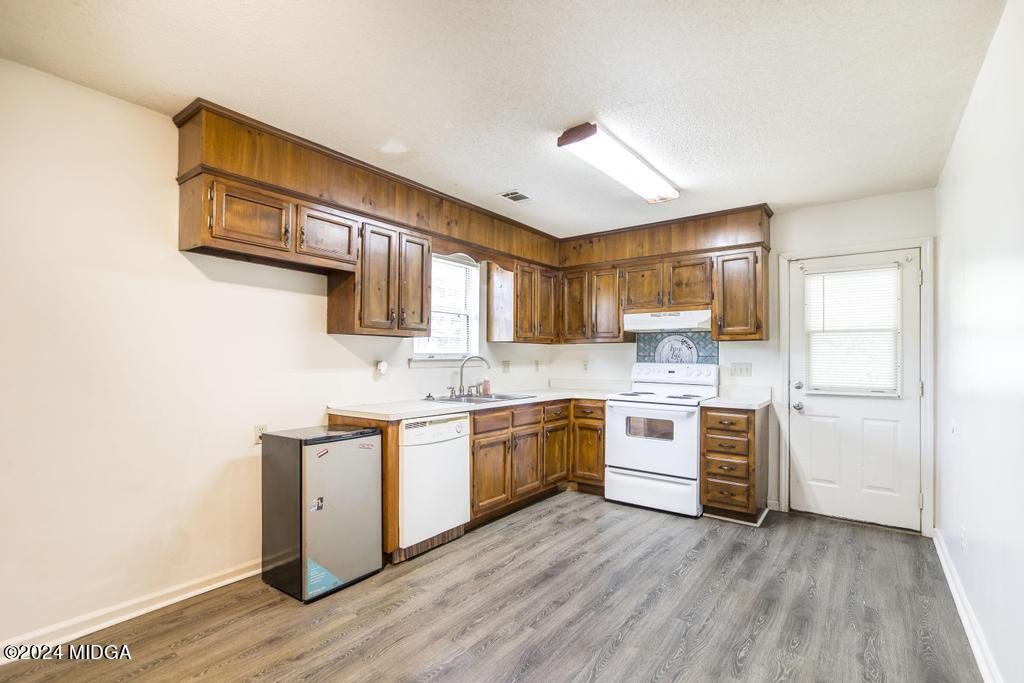 118 Toomer Road Perry, GA 31069 - Photo 13 of 30 a large kitchen with stainless steel appliances granite countertop a stove and a sink