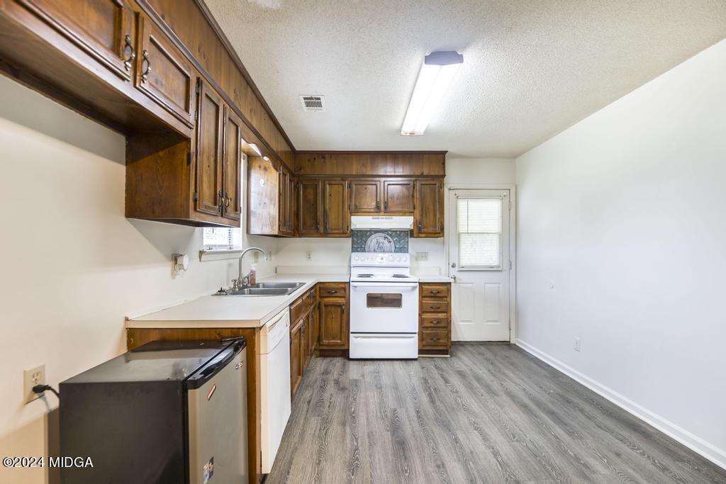 118 Toomer Road Perry, GA 31069 - Photo 15 of 30 a kitchen with a sink a stove and cabinets