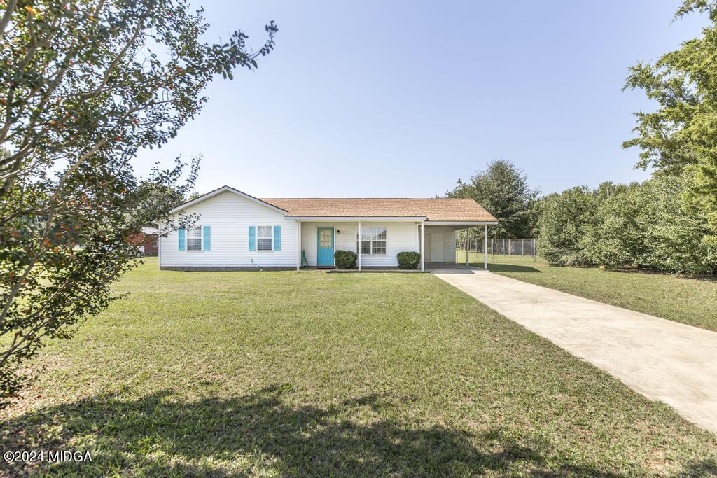 118 Toomer Road Perry, GA 31069 - Photo 2 of 30 a front view of house with yard and trees in the background