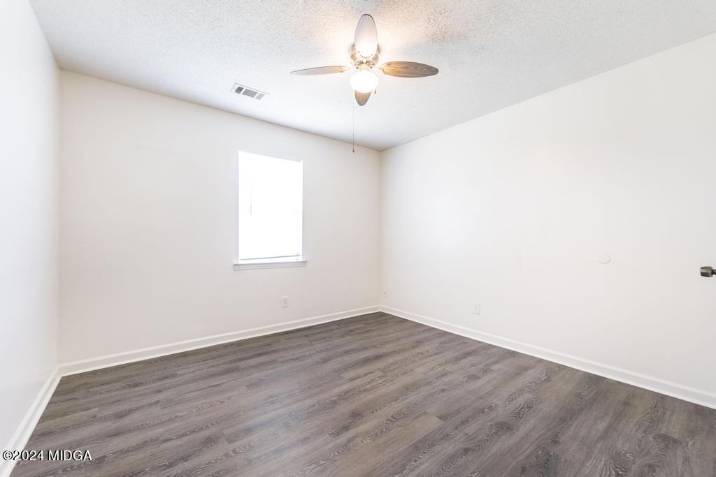 118 Toomer Road Perry, GA 31069 - Photo 22 of 30 an empty room with a window and a ceiling fan