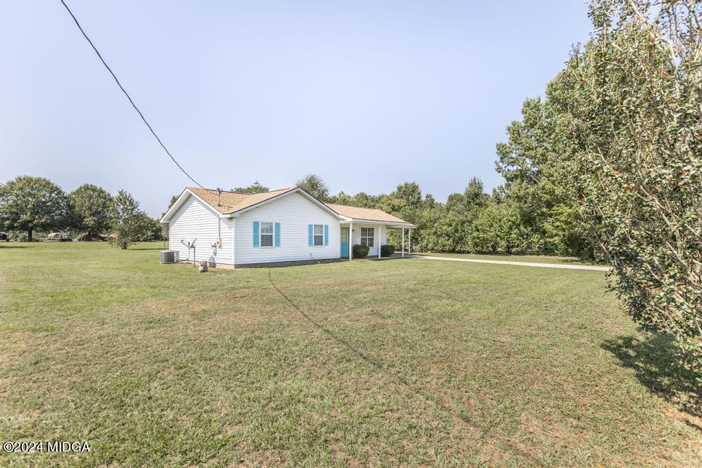 118 Toomer Road Perry, GA 31069 - Photo 4 of 30 a view of a house with a yard and a large tree