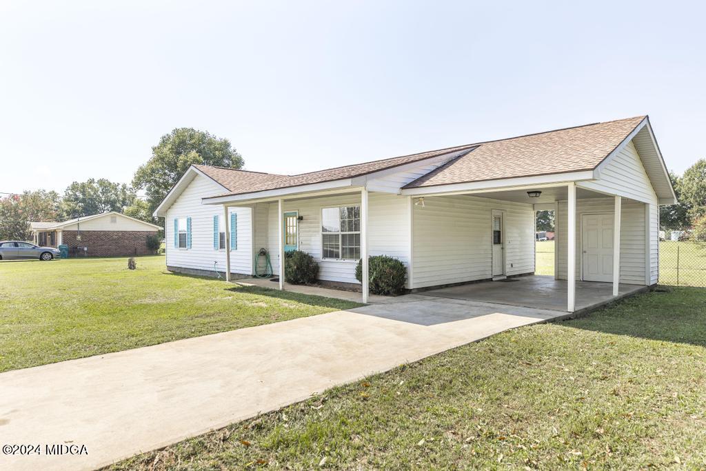 118 Toomer Road Perry, GA 31069 - Photo 6 of 30 a view of a house with a backyard and a tree