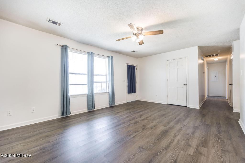 118 Toomer Road Perry, GA 31069 - Photo 10 of 30 a view of an empty room with a window and wooden floor