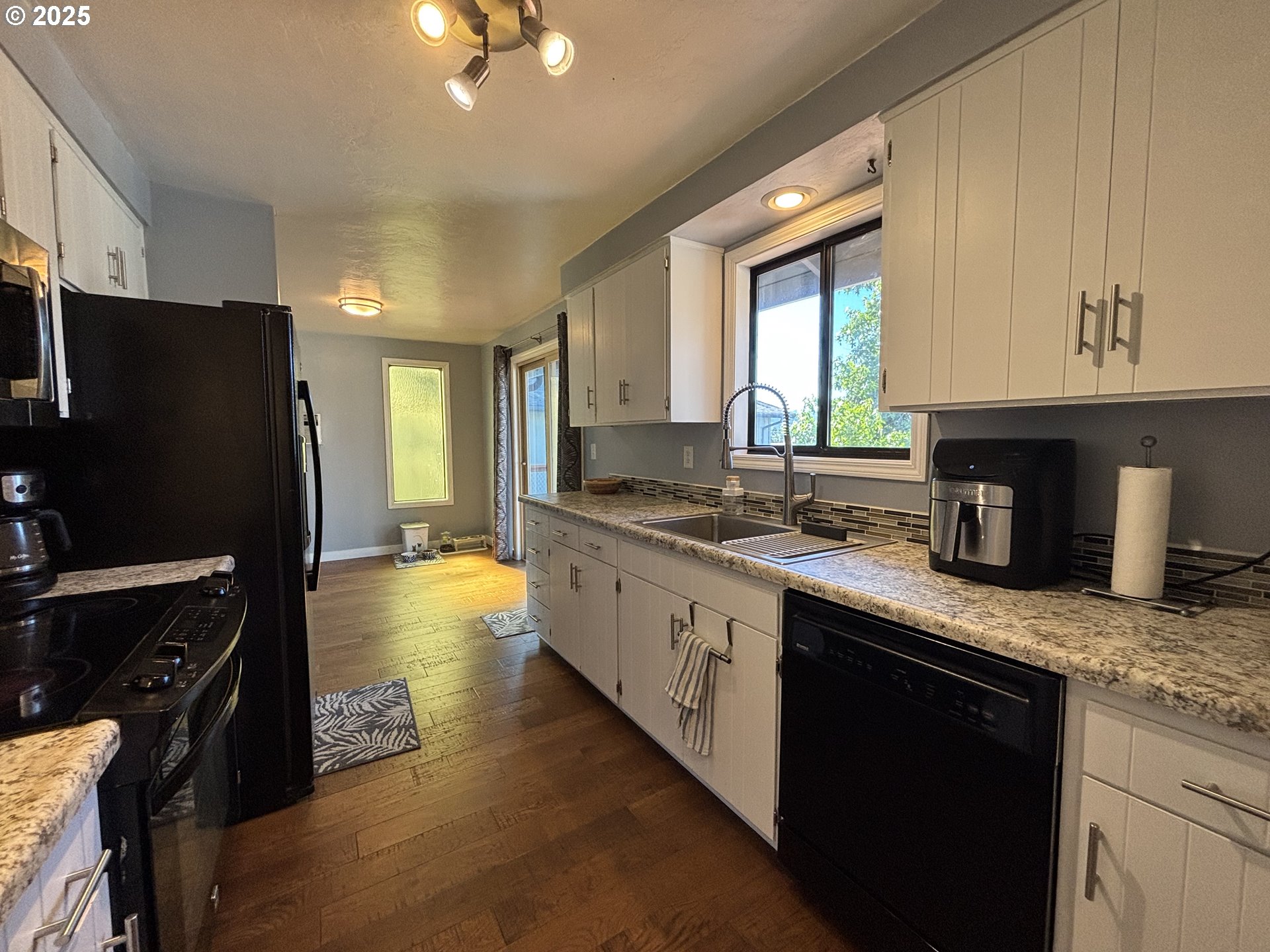 7066 Aster Street Springfield, OR 97478 - Photo 16 of 46 a kitchen with stainless steel appliances granite countertop a sink stove and refrigerator