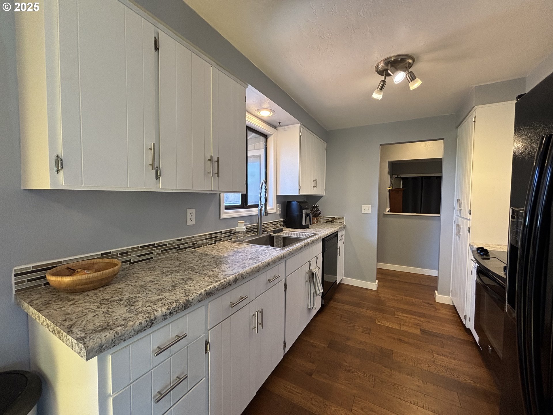 7066 Aster Street Springfield, OR 97478 - Photo 17 of 46 a kitchen with a sink stove and cabinets