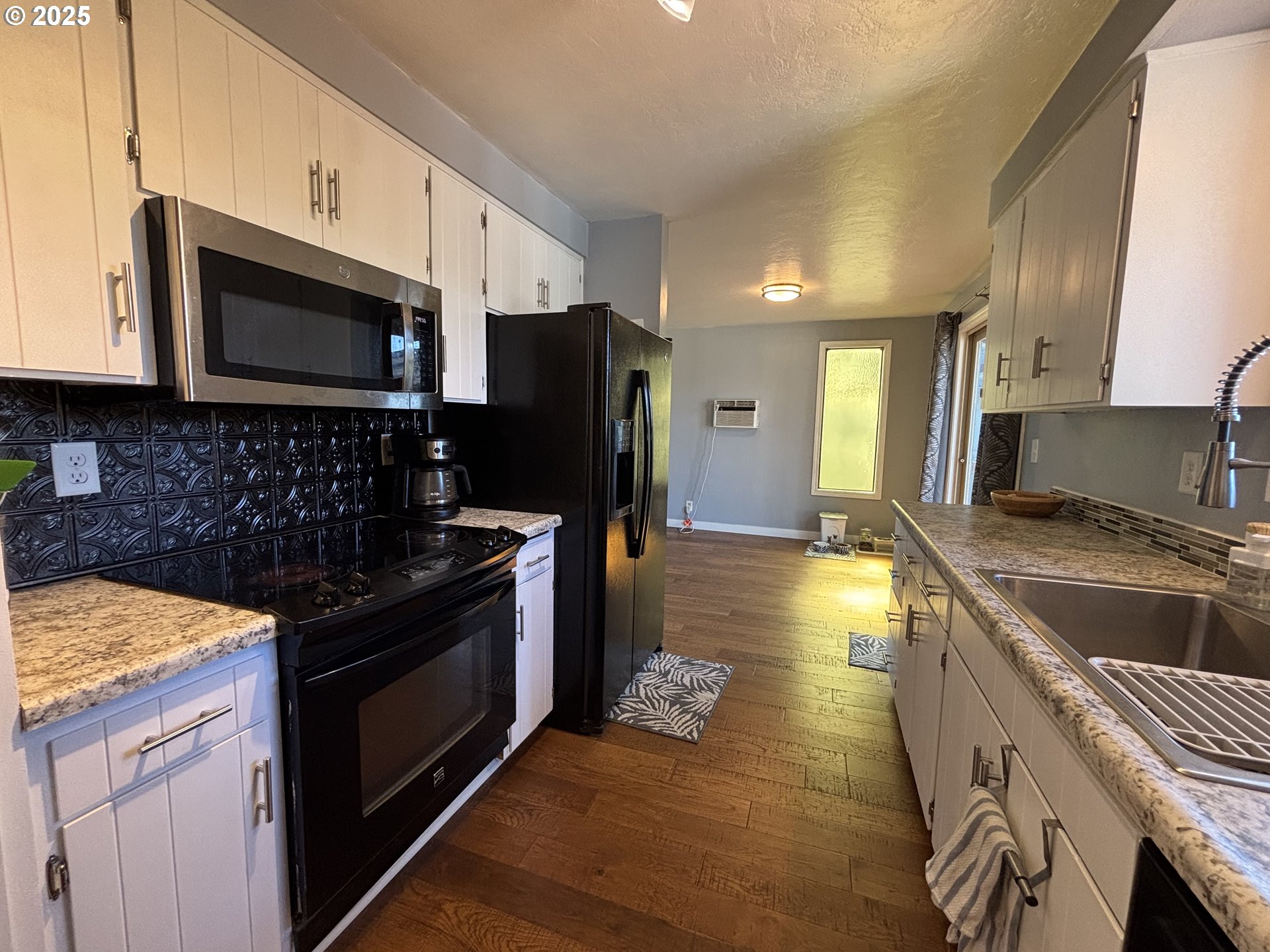 7066 Aster Street Springfield, OR 97478 - Photo 19 of 46 a kitchen with granite countertop a sink stainless steel appliances and cabinets