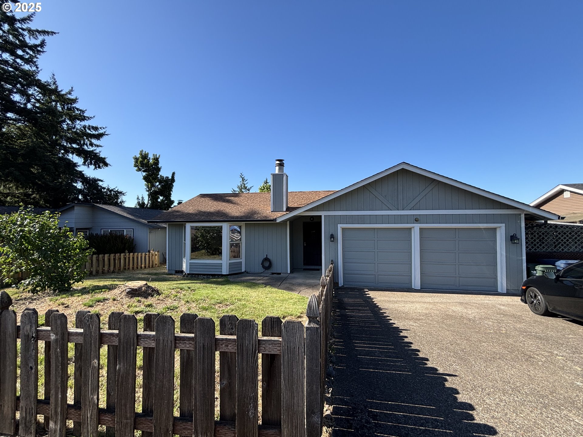 7066 Aster Street Springfield, OR 97478 - Photo 2 of 46 a front view of house with yard and trees in the background