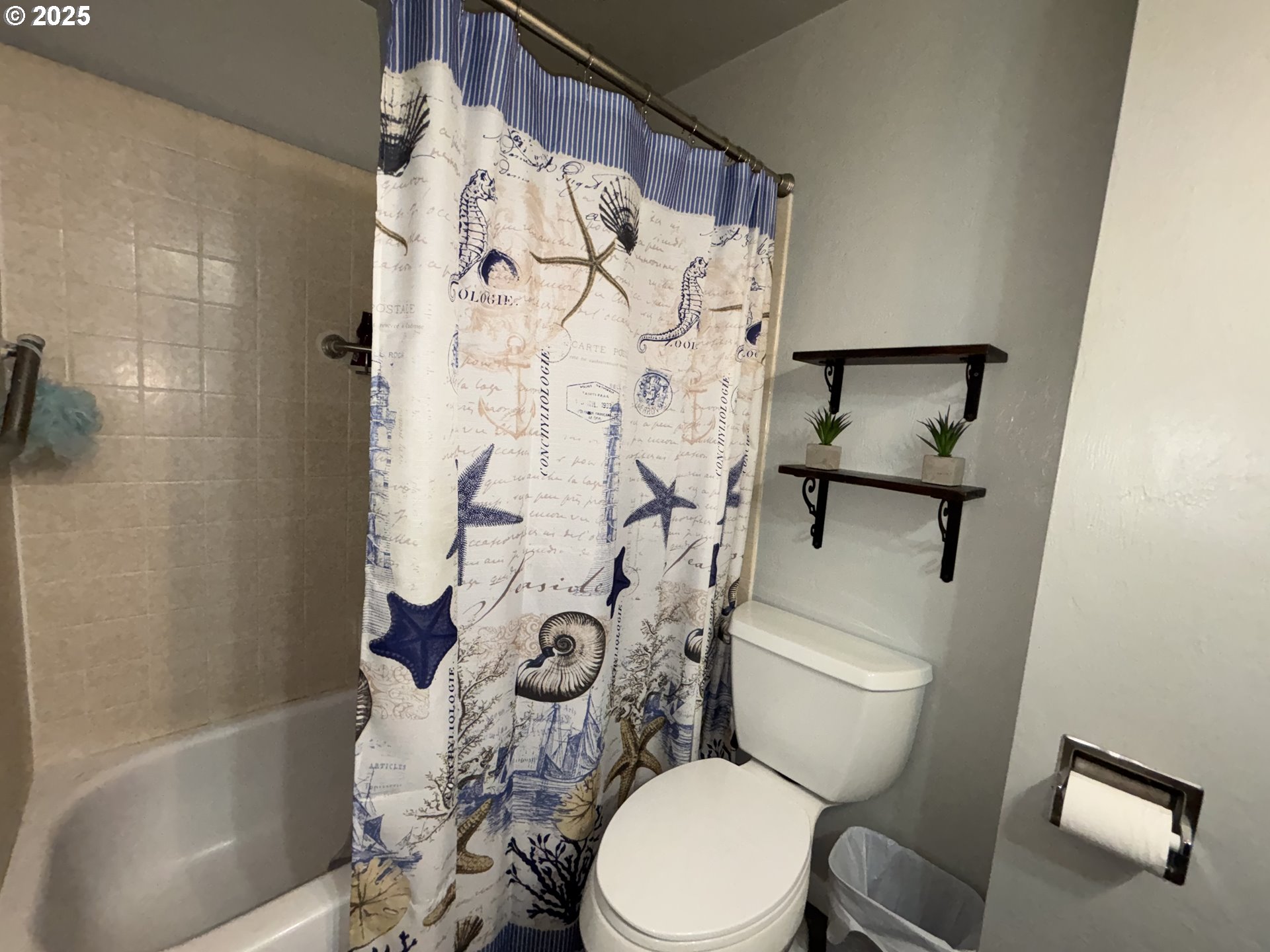 7066 Aster Street Springfield, OR 97478 - Photo 21 of 46 a white toilet sitting next to a bath tub