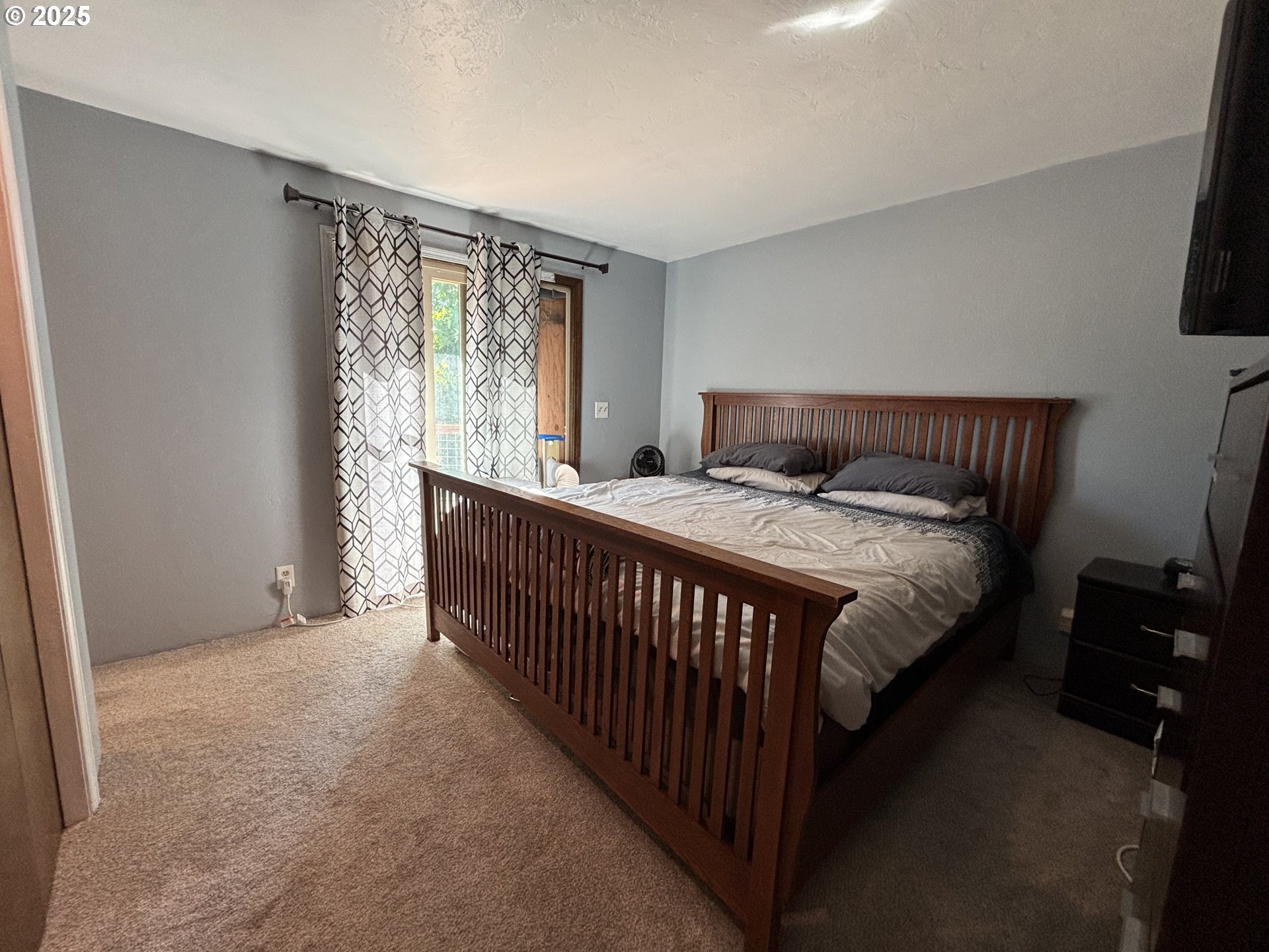 7066 Aster Street Springfield, OR 97478 - Photo 25 of 46 a bedroom with a bed and a window