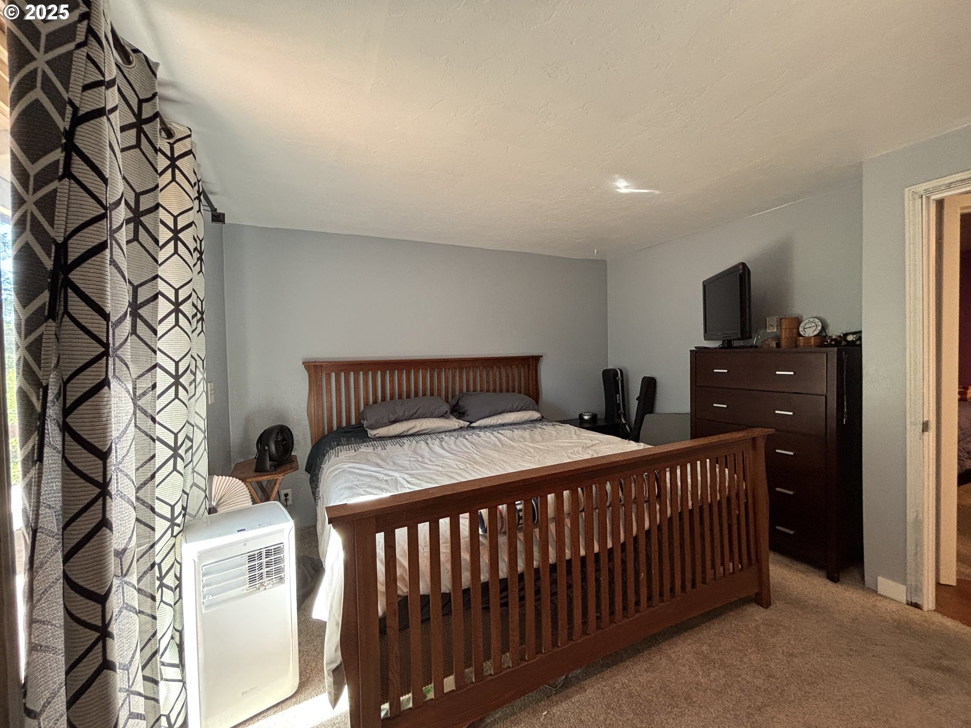 7066 Aster Street Springfield, OR 97478 - Photo 27 of 46 a bedroom with a bed and wooden floor
