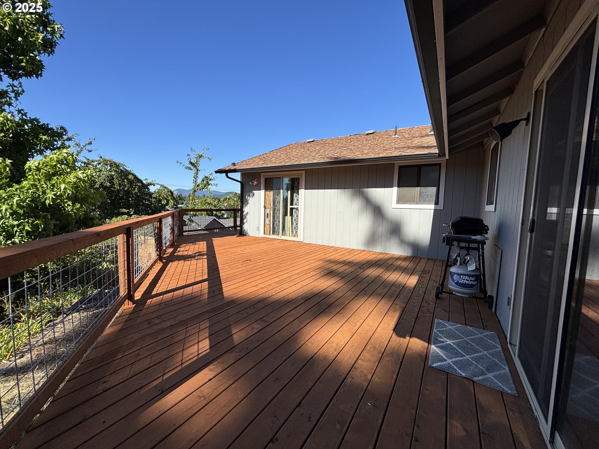 7066 Aster Street Springfield, OR 97478 - Photo 33 of 46 a view of backyard with a deck and wooden floor