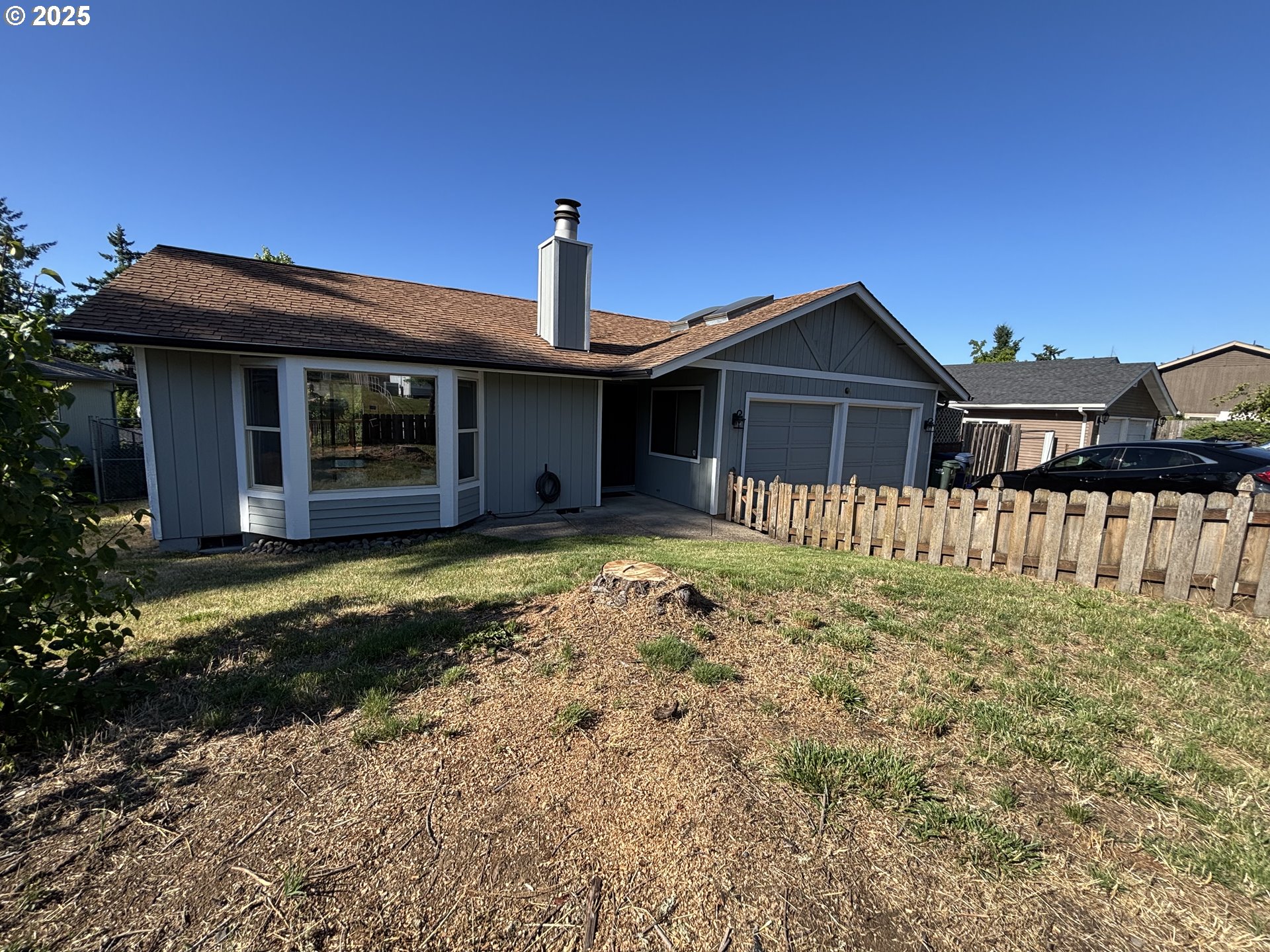 7066 Aster Street Springfield, OR 97478 - Photo 42 of 46 a front view of a house with a garden