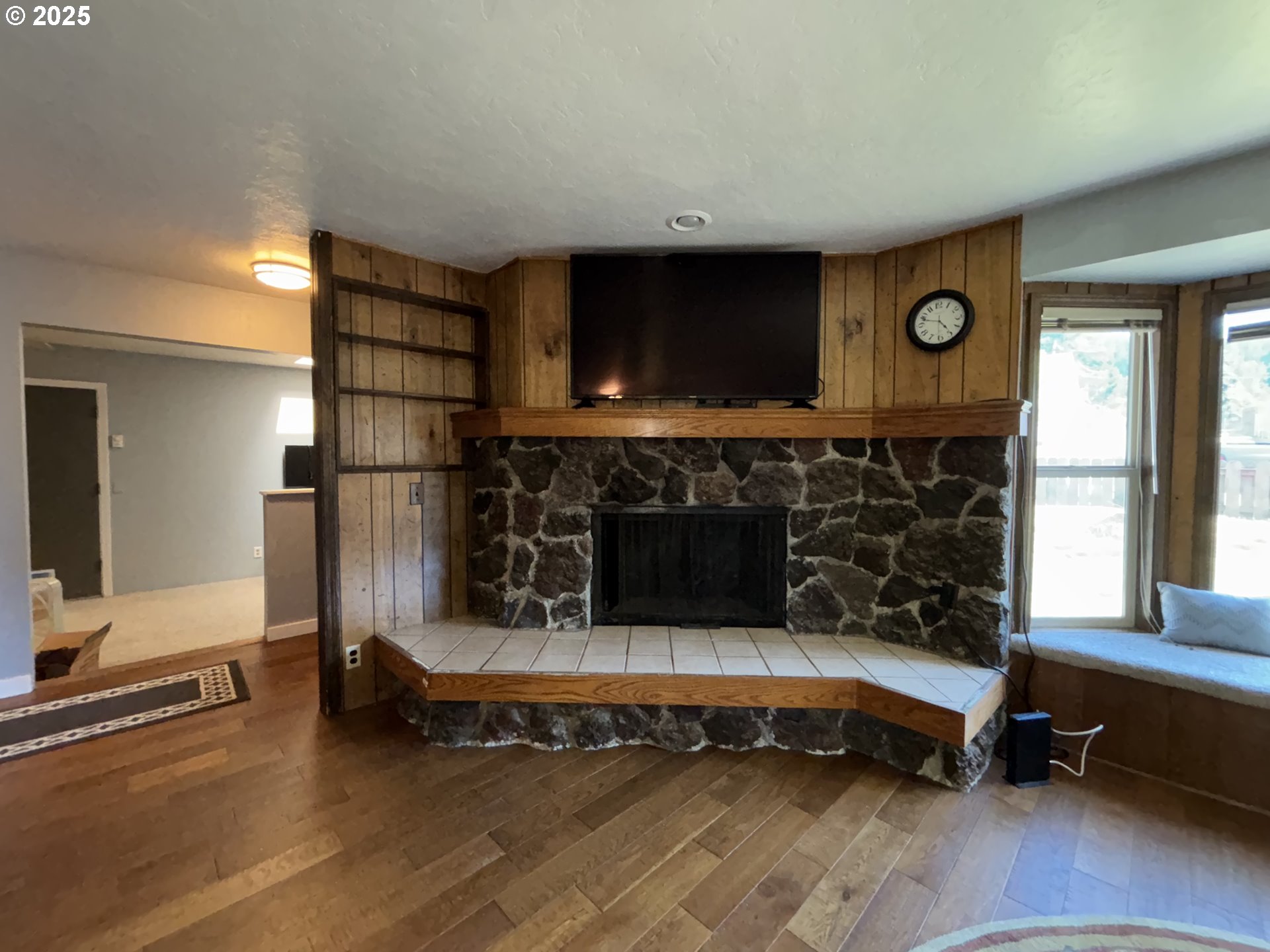7066 Aster Street Springfield, OR 97478 - Photo 6 of 46 a living room with furniture a flat screen tv and a fireplace