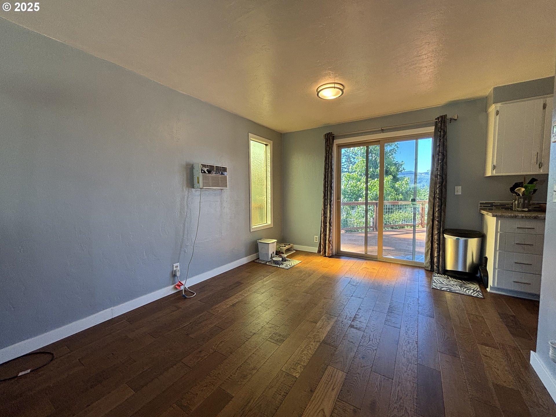 7066 Aster Street Springfield, OR 97478 - Photo 9 of 46 an empty room with wooden floor and windows