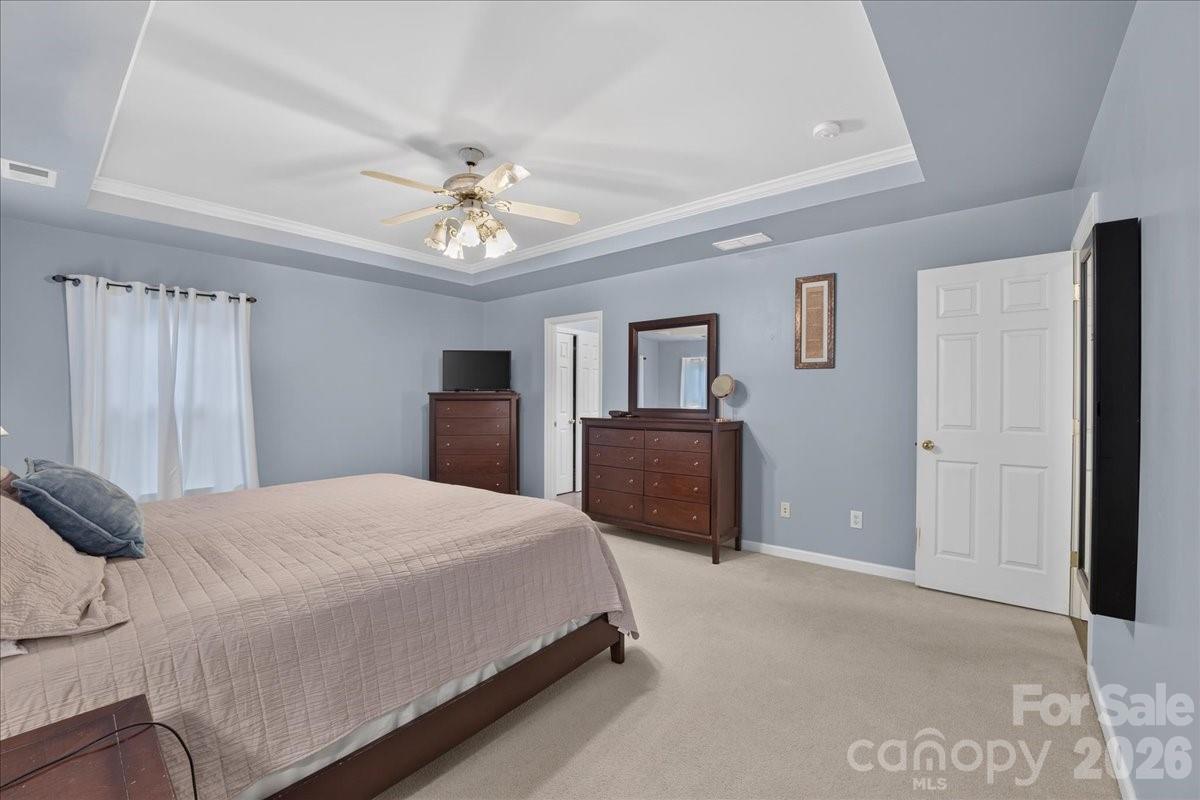 8006 Fine Robe Drive Indian Trail, NC 28079 - Photo 26 of 36 a bedroom with a bed and a chandelier