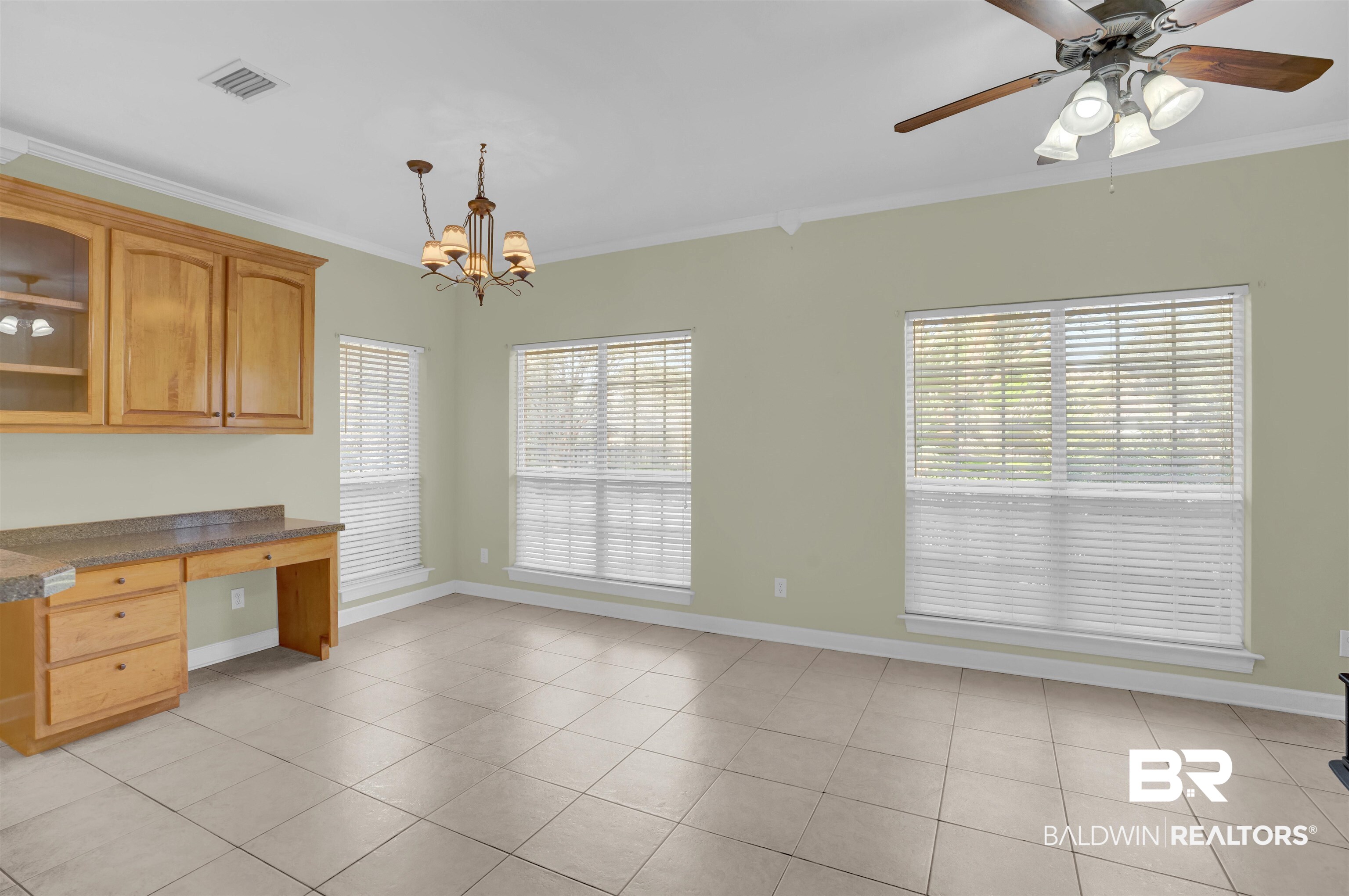 100 Conti Court Fairhope, AL 36532 - Photo 26 of 54 Kitchen featuring crown molding, plenty of natural light, light tile patterned floors, and decorative light fixtures