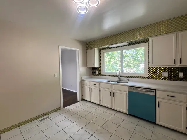 a kitchen with a sink cabinets and window