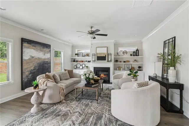 a living room with fireplace furniture and a large window