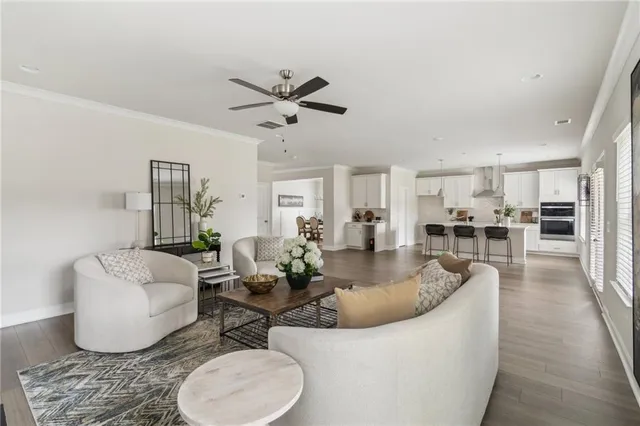 a living room with furniture and a view of kitchen