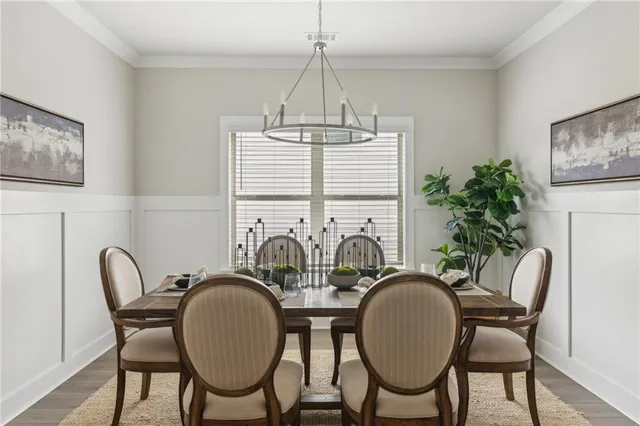 a view of a dining room with furniture window and wooden floor