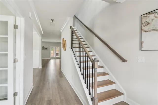 a view of a hallway with wooden floor and entryway