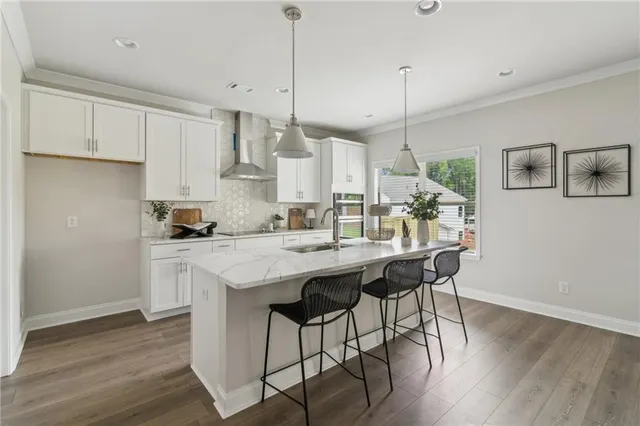 a kitchen with stainless steel appliances granite countertop a white cabinets and wooden floor