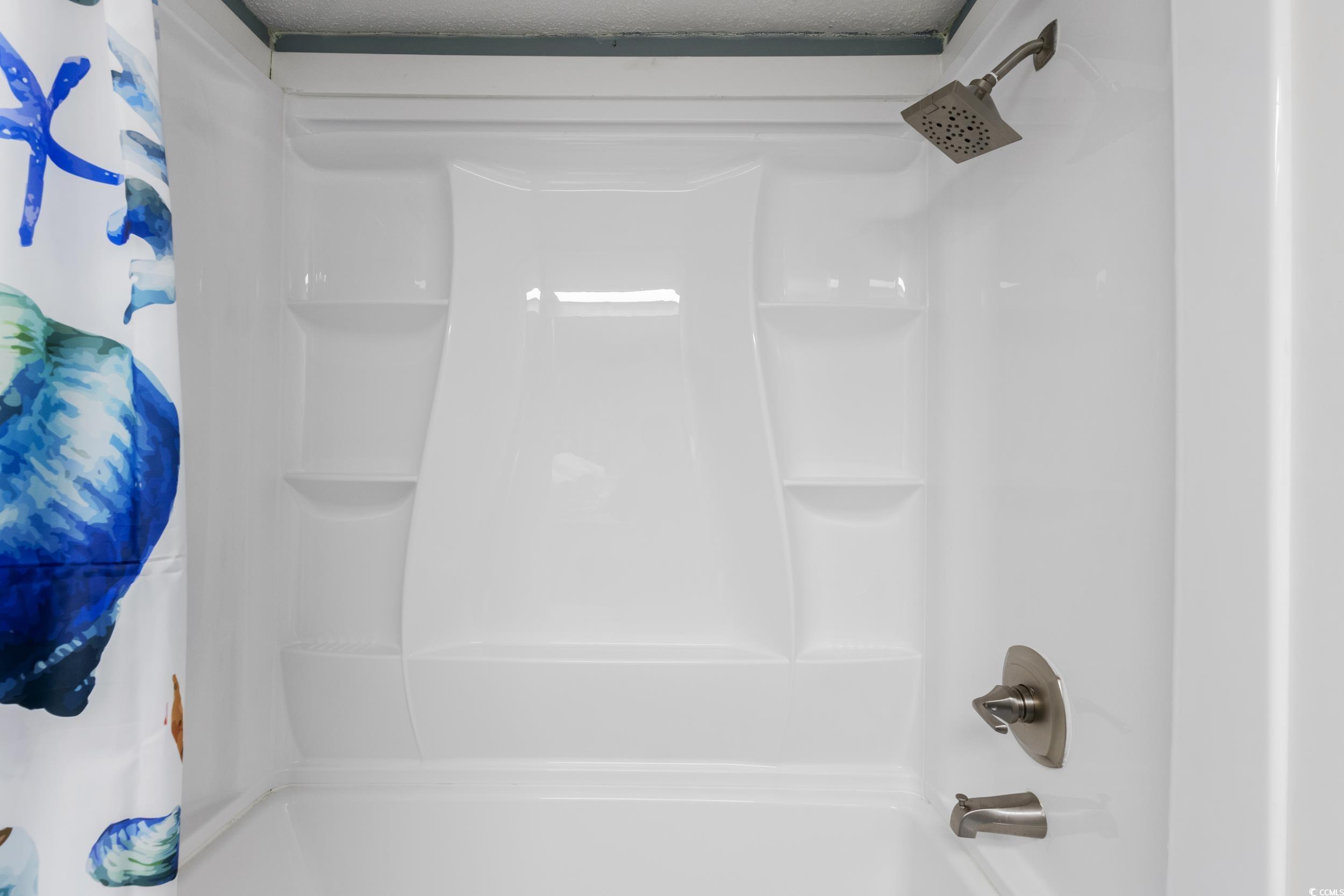 1207 South Ocean Boulevard, Unit 20603 Myrtle Beach, SC 29577 - Photo 11 of 19 Bathroom featuring shower / bath combination with curtain