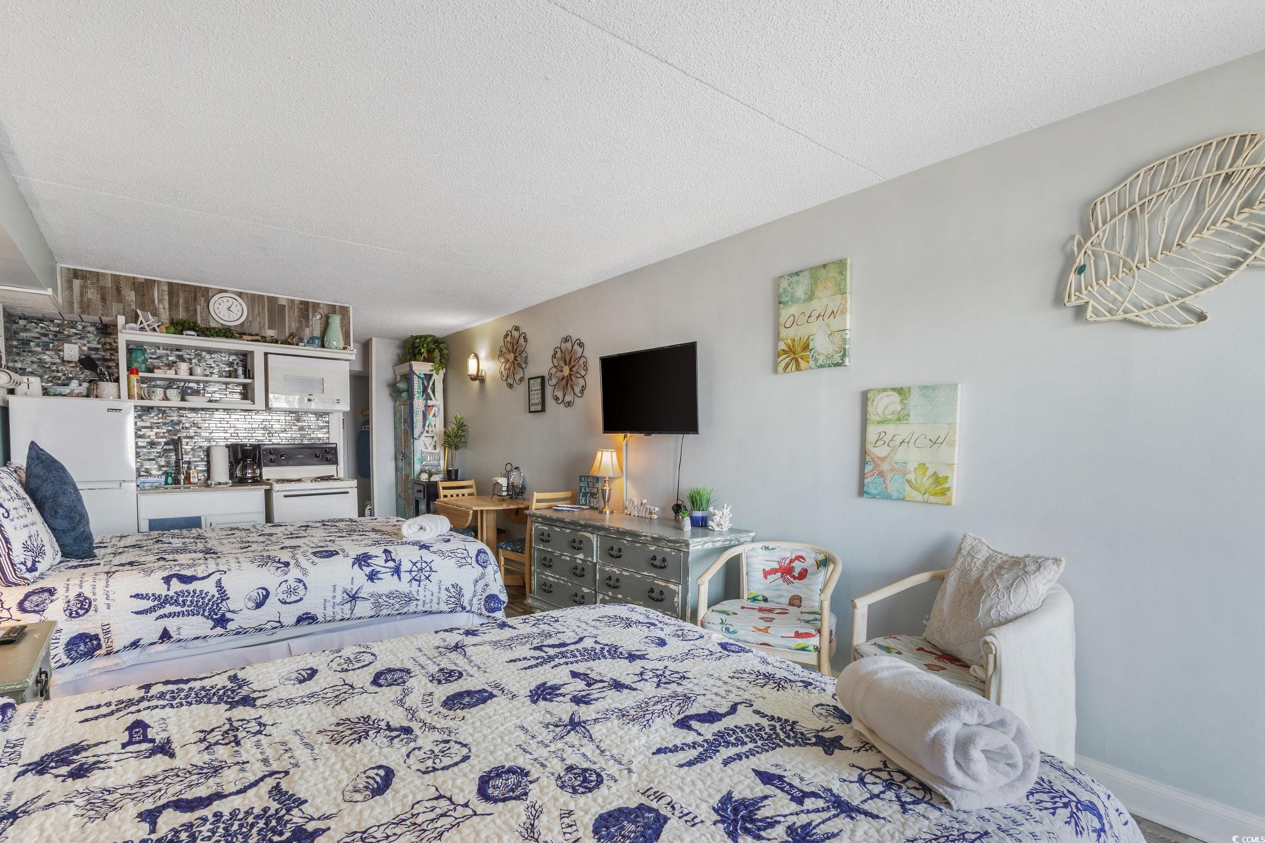 1207 South Ocean Boulevard, Unit 20603 Myrtle Beach, SC 29577 - Photo 8 of 19 Bedroom featuring a textured ceiling and freestanding refrigerator