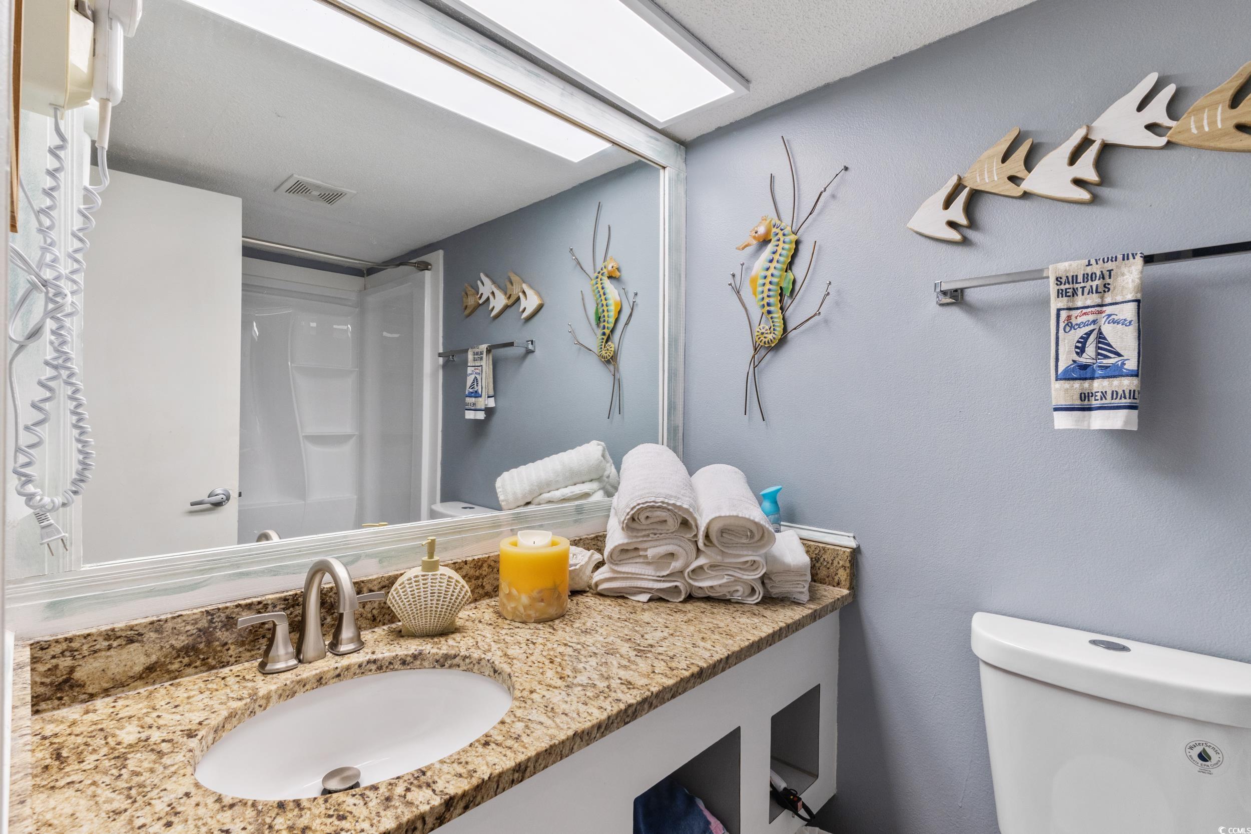 1207 South Ocean Boulevard, Unit 20603 Myrtle Beach, SC 29577 - Photo 10 of 19 Bathroom featuring a shower with shower curtain and vanity
