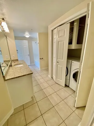 a view of a storage & utility room with sink dryer and washer