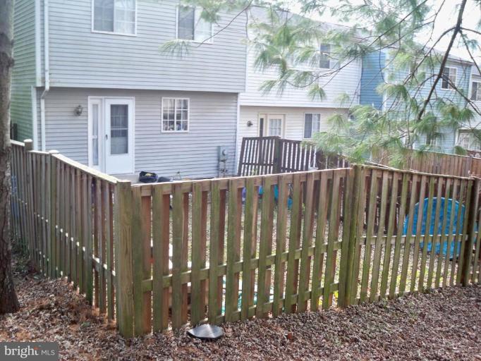 10501 Apple Ridge Road Gaithersburg, MD 20886 - Photo 2 of 15 a view of a house with a wooden fence