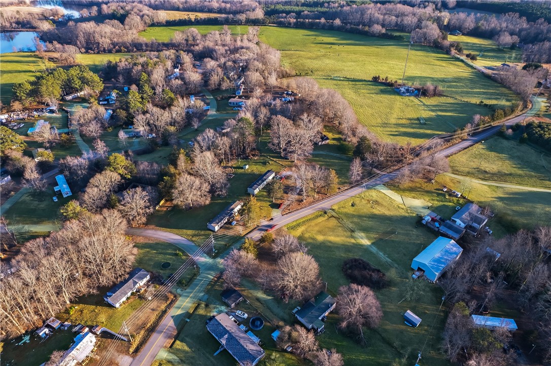 862 North Old Mill Road Easley, SC 29640 - Photo 22 of 24 An aerial perspective reveals a rural landscape with scattered homes amidst green fields and bare trees.