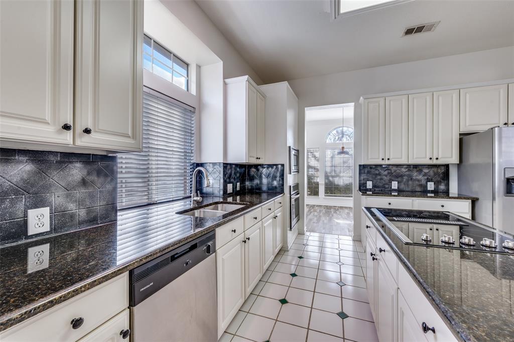 9611 Cliffside Drive Irving, TX 75063 - Photo 11 of 24 a kitchen with stainless steel appliances granite countertop a sink a stove and cabinets